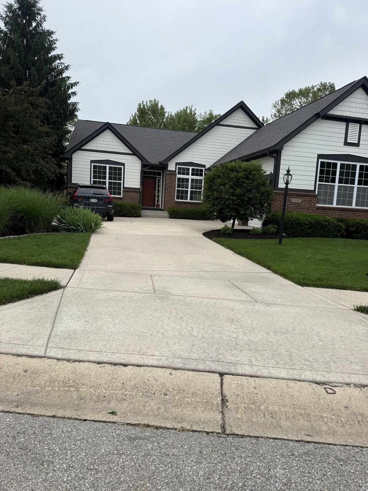 Same concrete driveway after pressure washing, clean