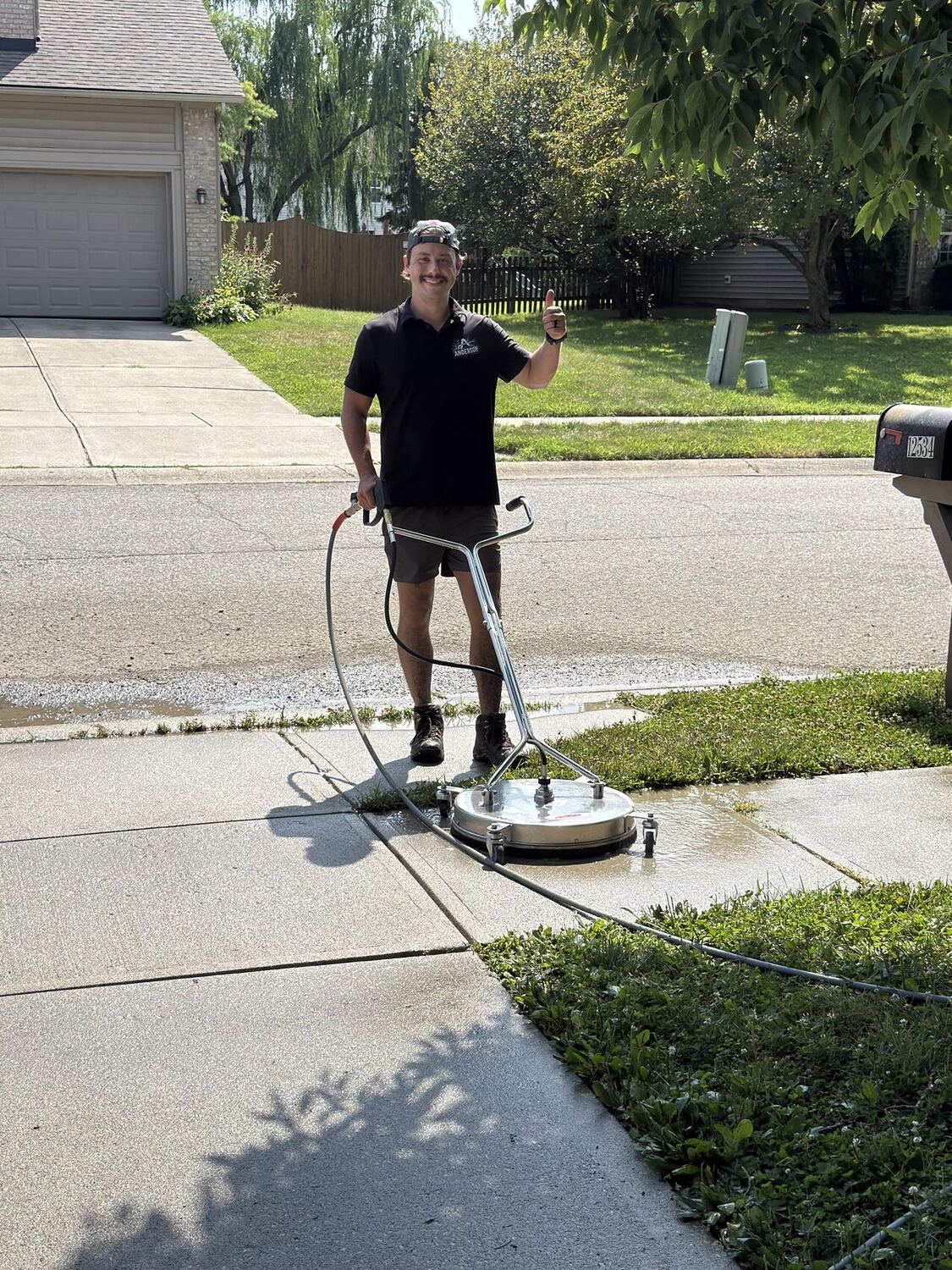 Anderson Exterior Cleaning surface cleaning a concrete driveway in Indianapolis, IN