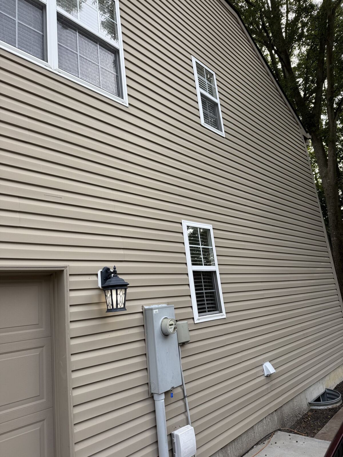 Same home siding after house washing, clean and streak-free