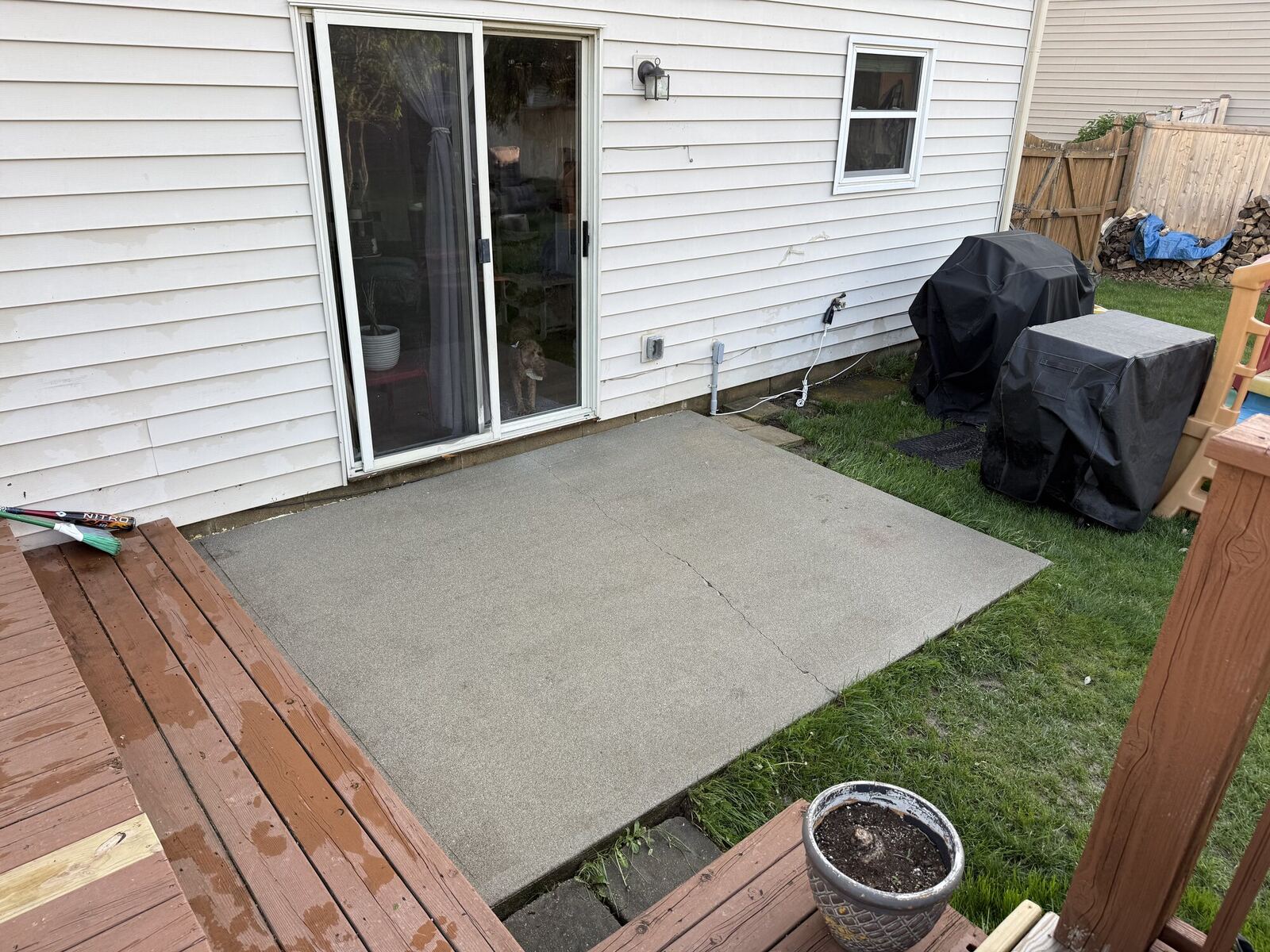 Same concrete patio after cleaning, dirt and algae removed