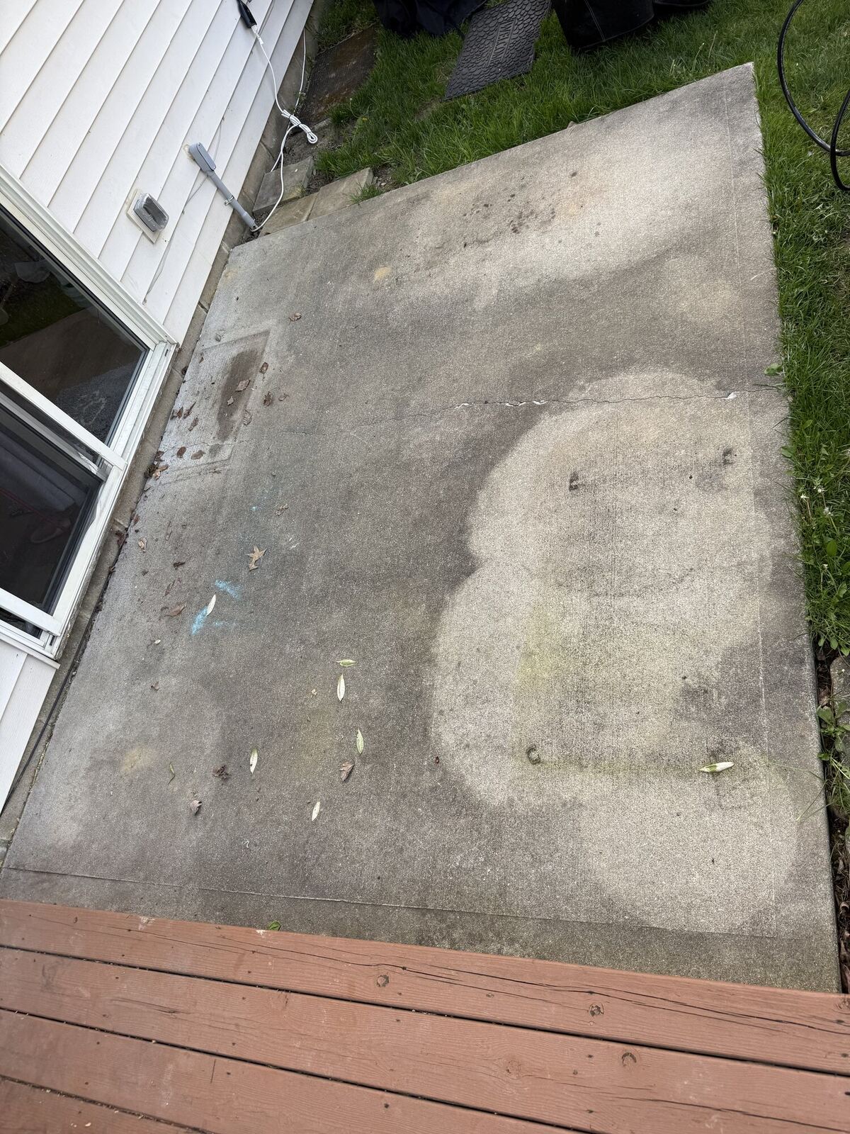 Concrete patio before cleaning, with dirt and algae buildup