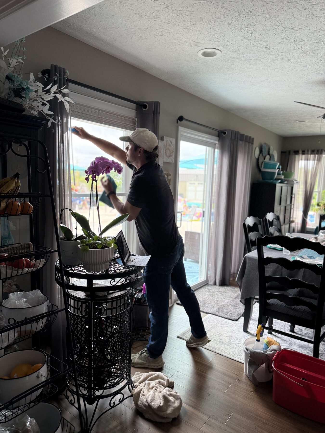 Anderson Exterior Cleaning technician washing an interior window in Indianapolis, IN