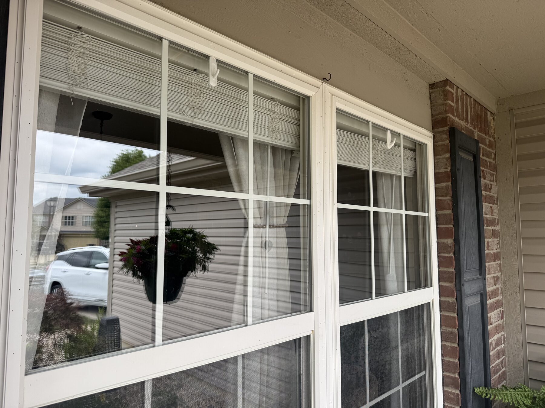 Close-up of clean window glass reflecting the neighborhood